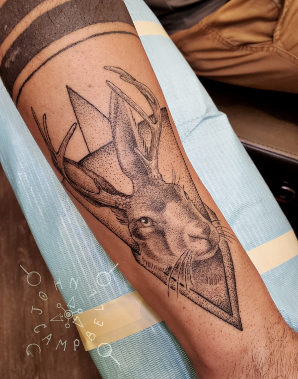 Black and grey tattoo of a Rabbit with antlers by John Campbell at Sacred Mandala Studio tattoo parlor in Durham, NC.
